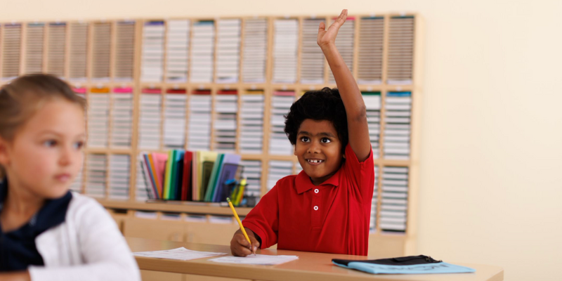 learning center franchise student raising their hand to answer their instructor